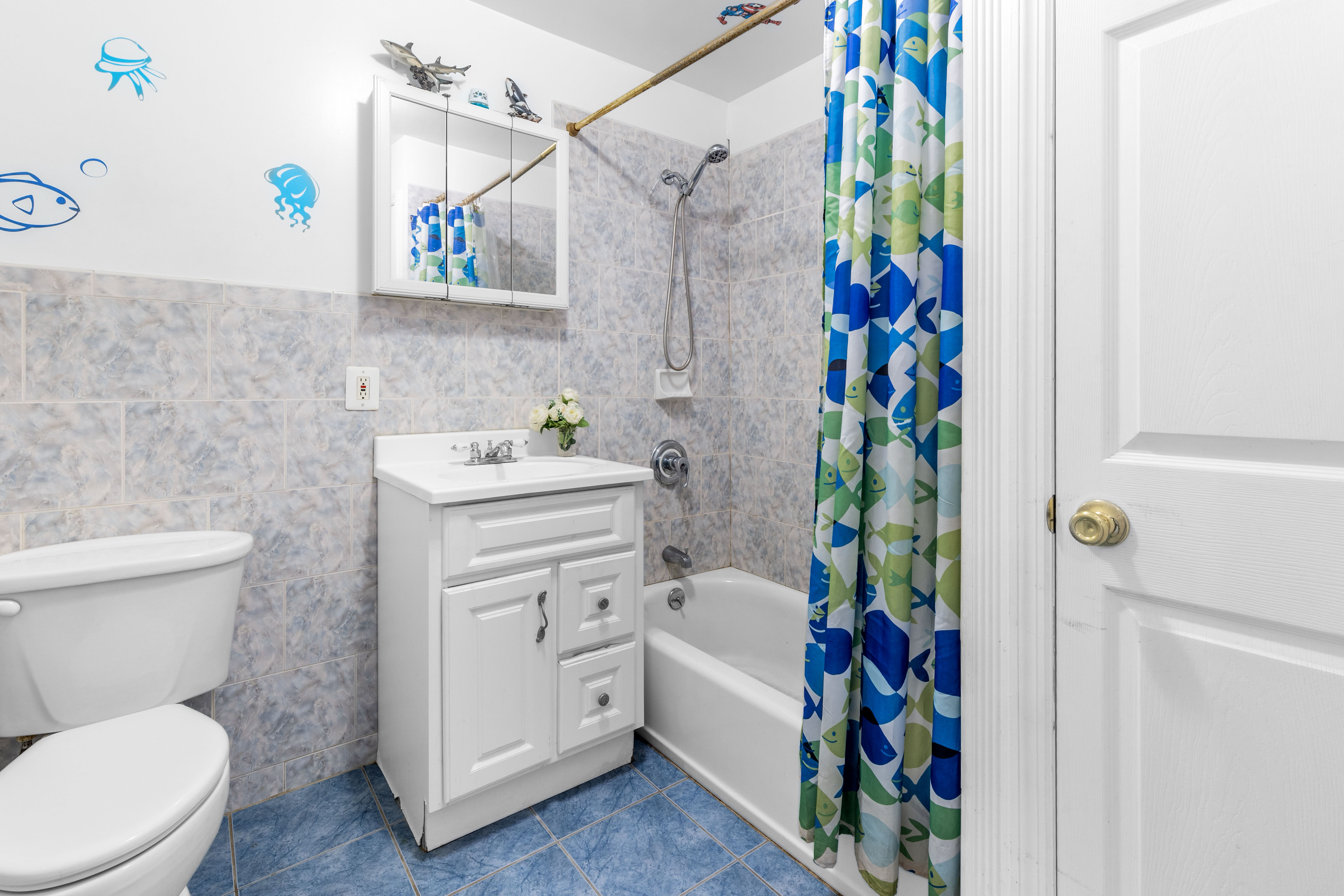 266 18th Street Brooklyn, NY 11215 - Photo 10 of 20 a bathroom with a sink a toilet and a shower curtain