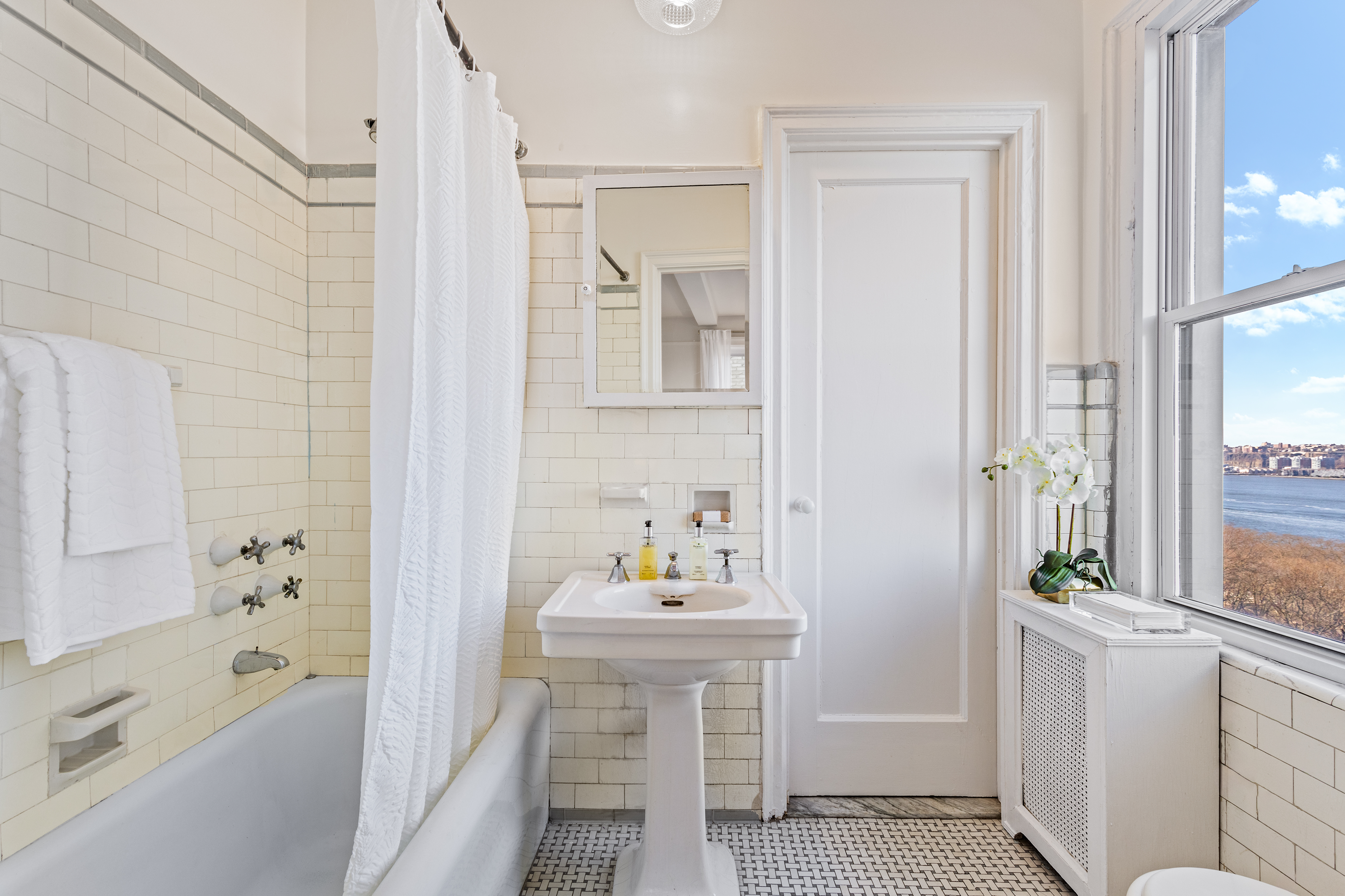 320 Riverside Drive, Unit 10G Manhattan, NY 10025 - Photo 11 of 16 a bathroom with a sink a toilet and shower