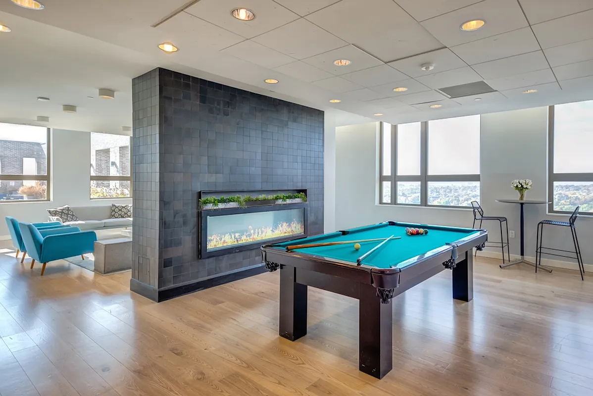 626 Flatbush Avenue, Unit 7E Brooklyn, NY 11225 - Photo 12 of 23 a living room with furniture a fireplace and a table