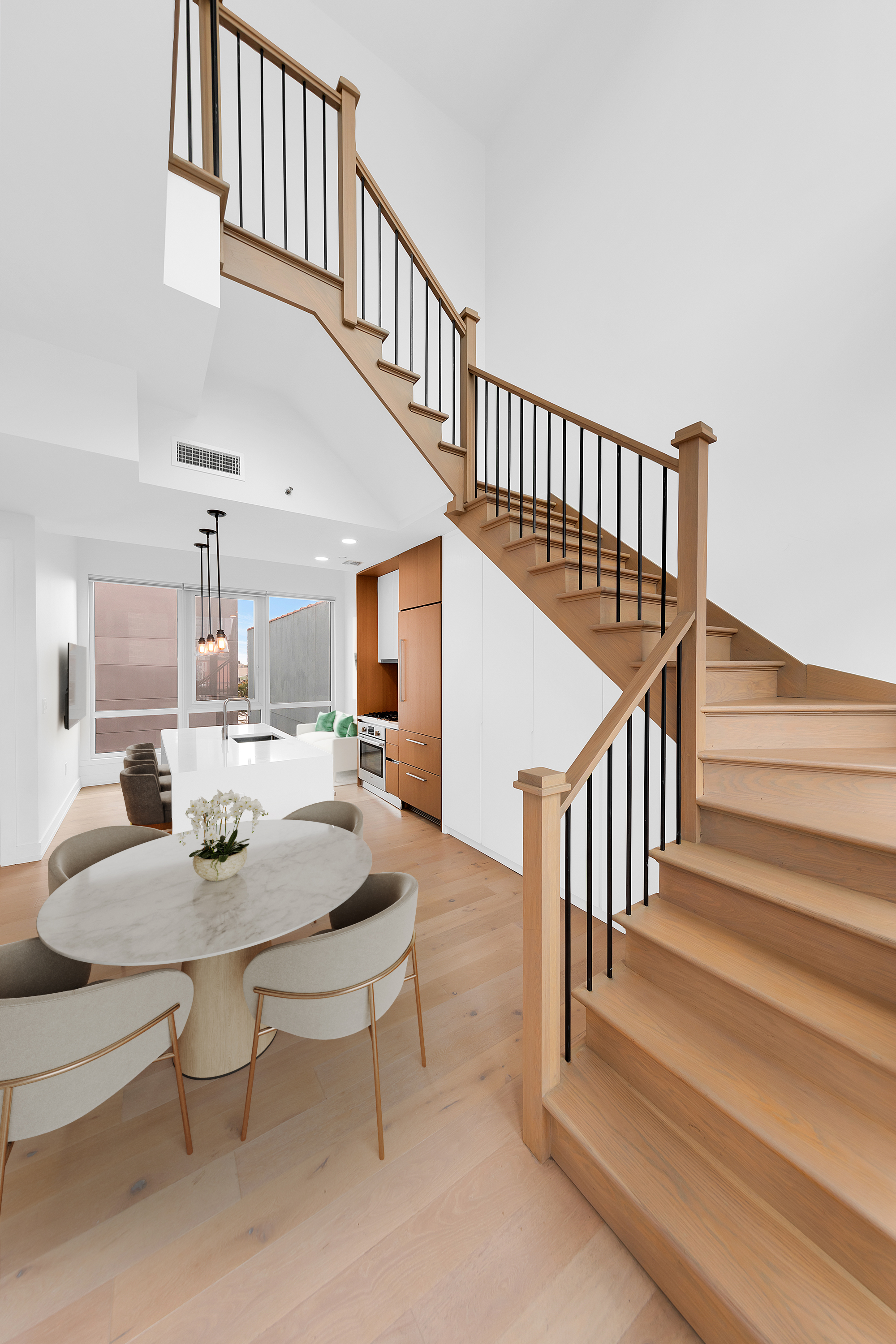 a dining room with furniture a rug and a floor to ceiling window