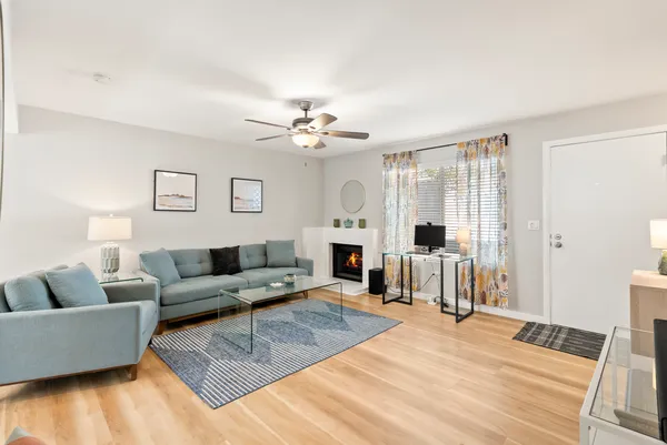 a living room with furniture and a chandelier
