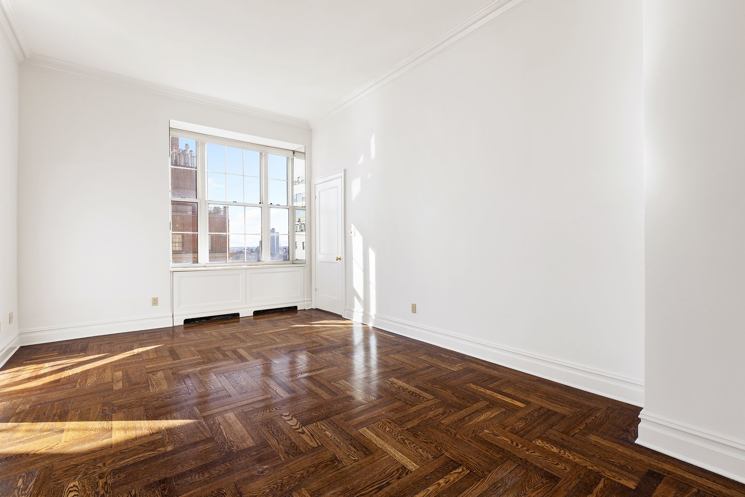 30 Sutton Place, Unit 14B Manhattan, NY 10022 - Photo 6 of 10 an empty room with wooden floor and windows