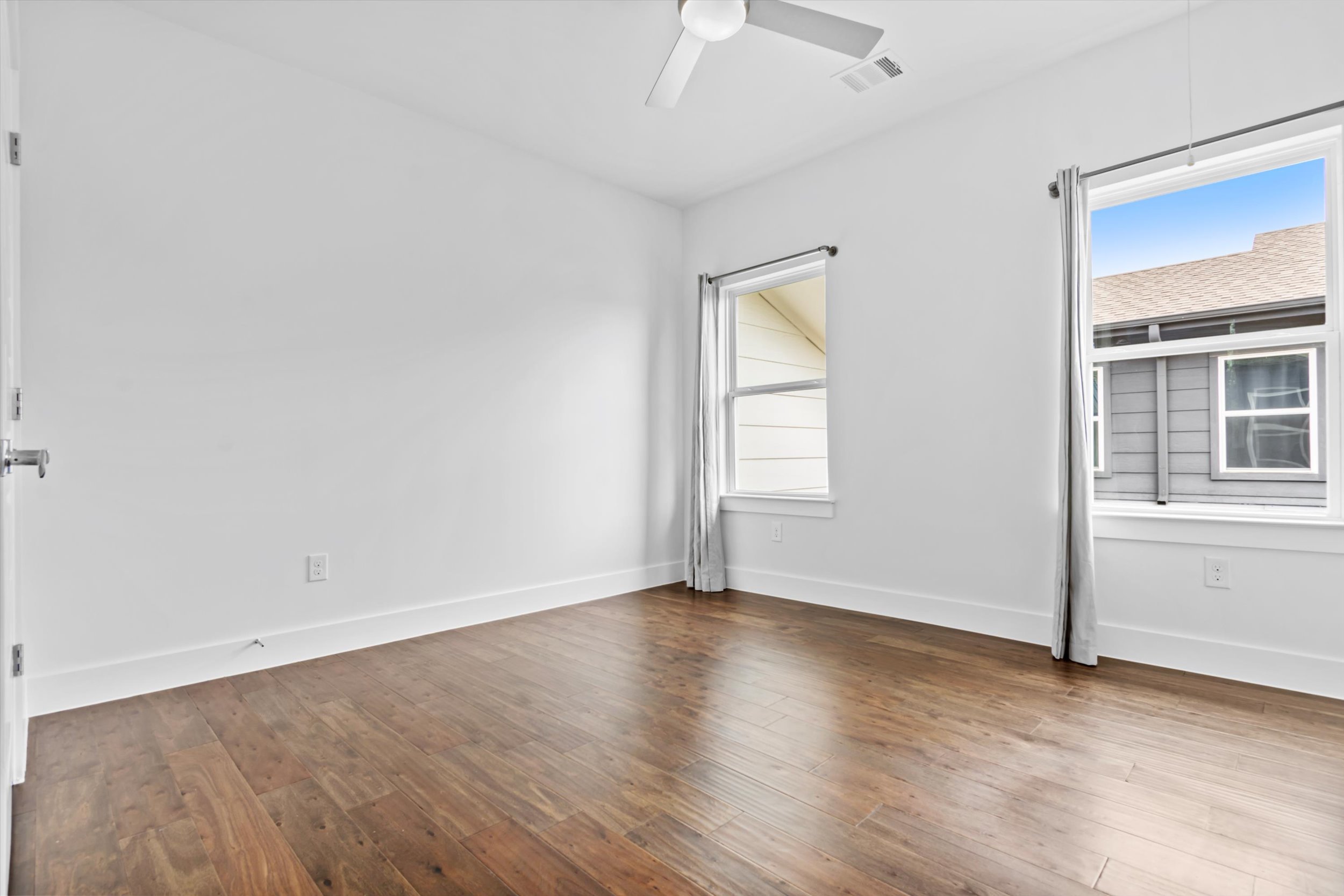 513 West Croslin Street, Unit A Austin, TX 78752 - Photo 21 of 39 an empty room with wooden floor and windows