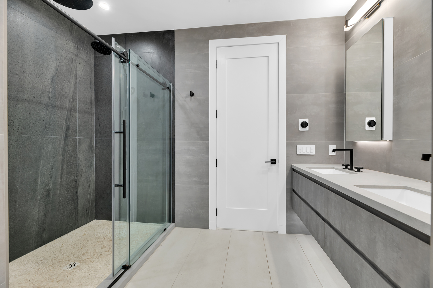 38-26 29th Street, Unit 2 Queens, NY 11101 - Photo 8 of 14 a bathroom with a double vanity sink and mirror