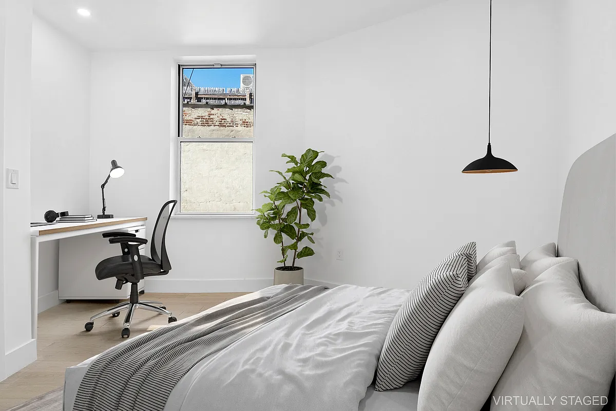 457 Bergen Street, Unit 2F Brooklyn, NY 11217 - Photo 9 of 12 a bedroom with a bed and a potted plant