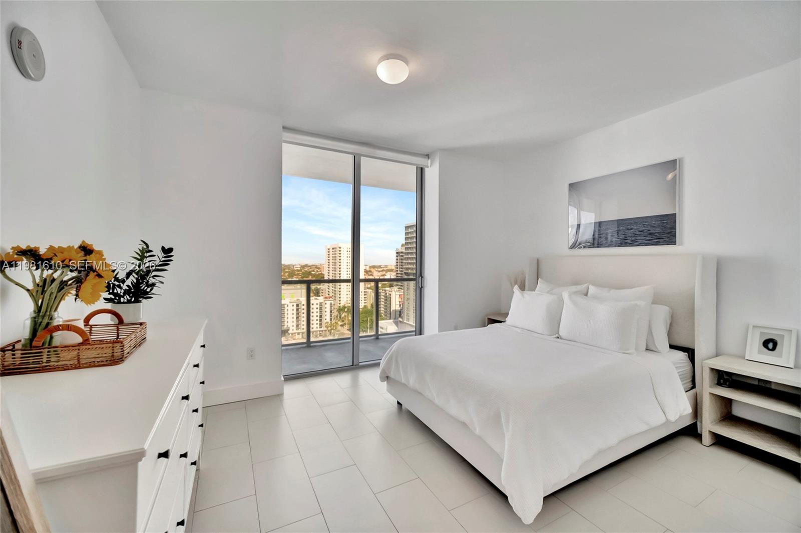 79 Southwest 12th Street, Unit 2201S Miami, FL 33130 - Photo 15 of 33 a bedroom with a large bed and a window