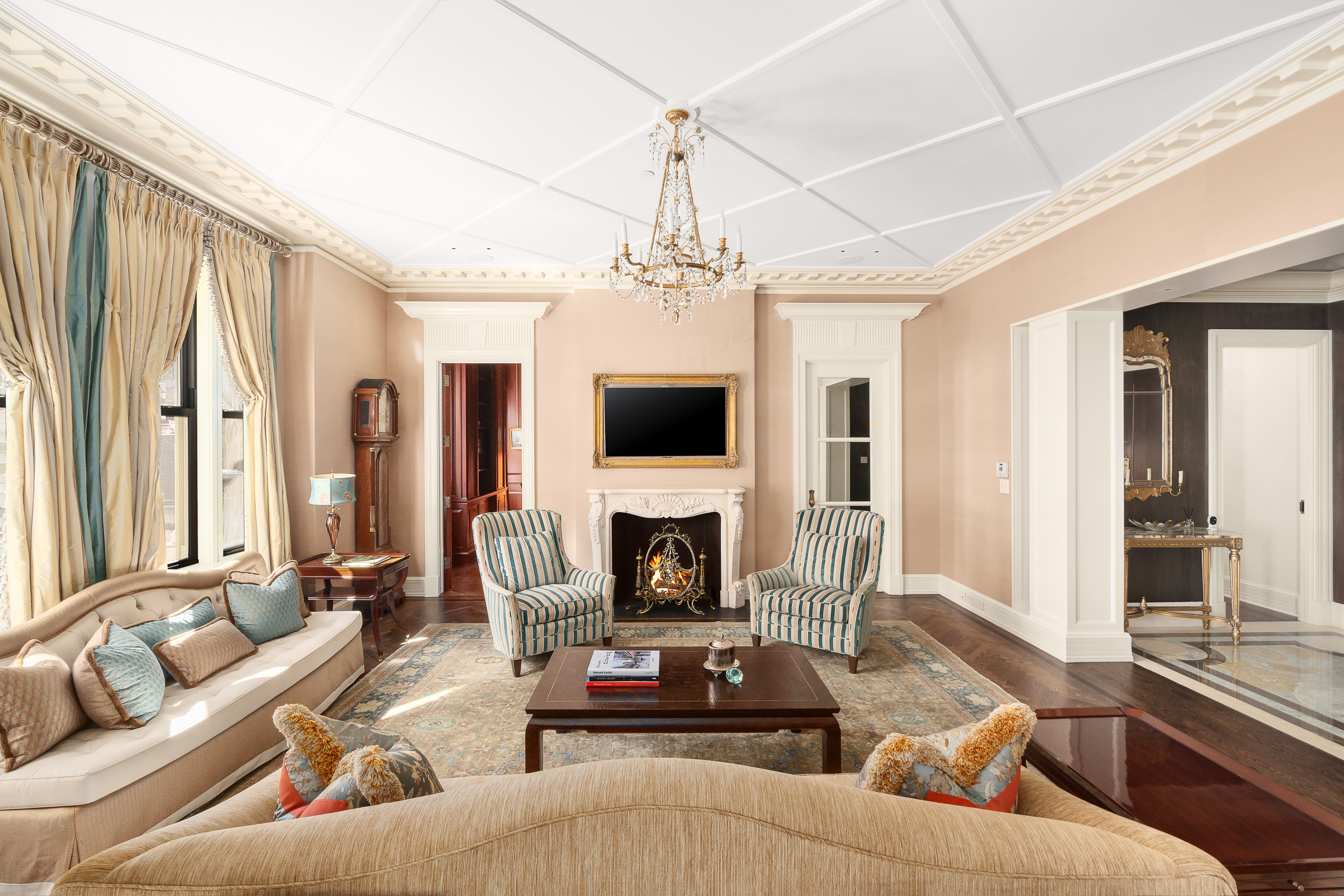 1 Central Park South, Unit 1013 Manhattan, NY 10019 - Photo 3 of 32 a living room with furniture a fireplace and a flat screen tv