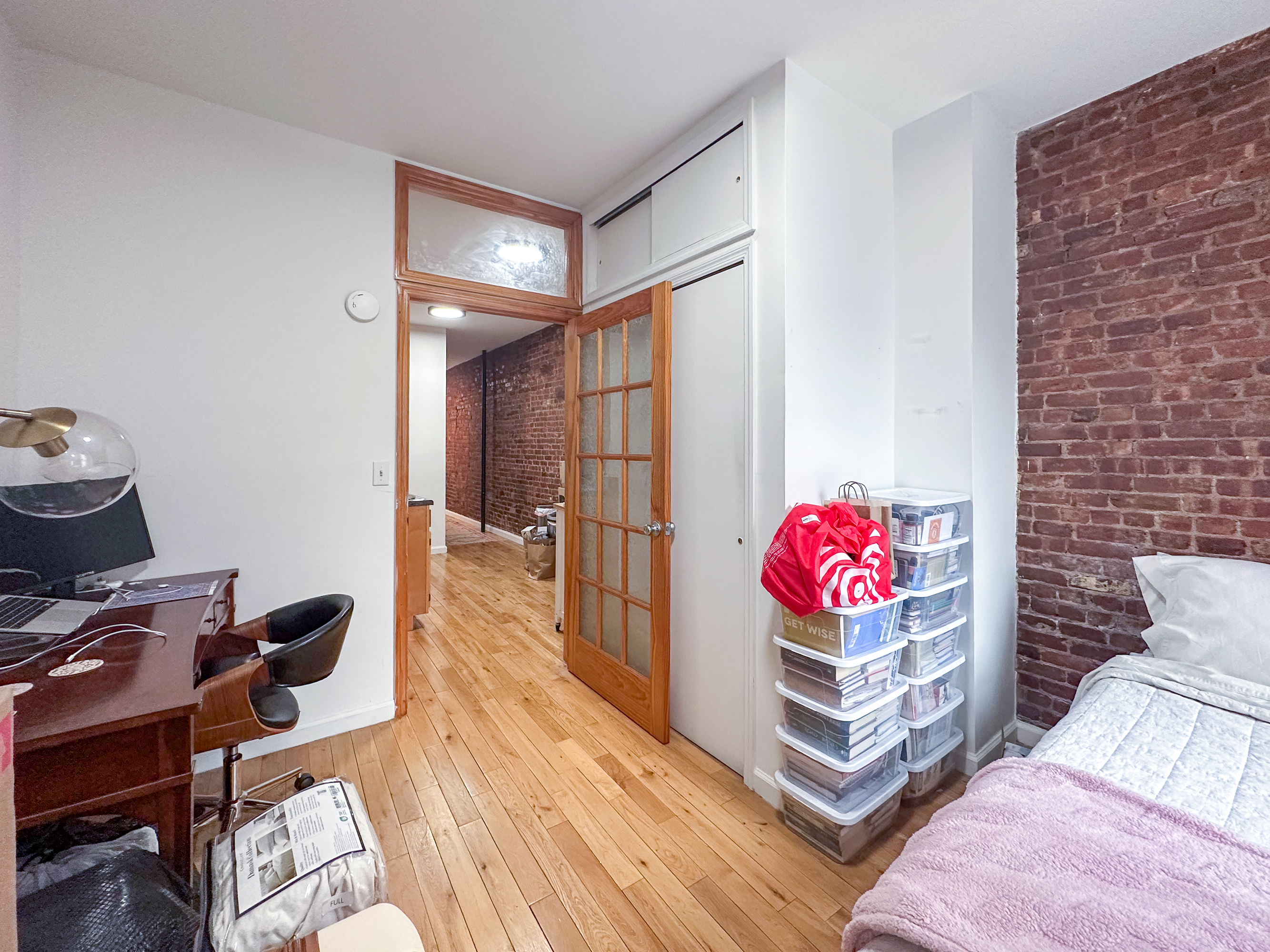 215 East 5th Street, Unit 7 Manhattan, NY 10003 - Photo 10 of 15 a living room with furniture and a wooden floor