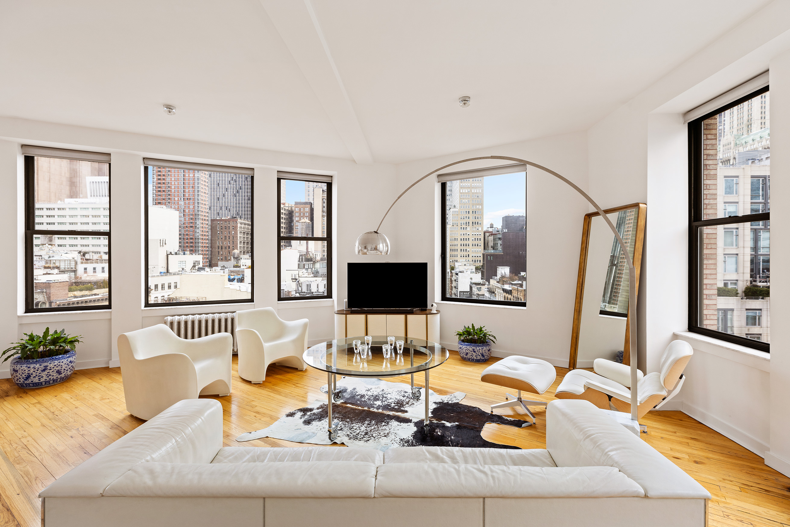 1 Hudson Street, Unit 9 Manhattan, NY 10013 - Photo 1 of 13 a living room with furniture and large windows