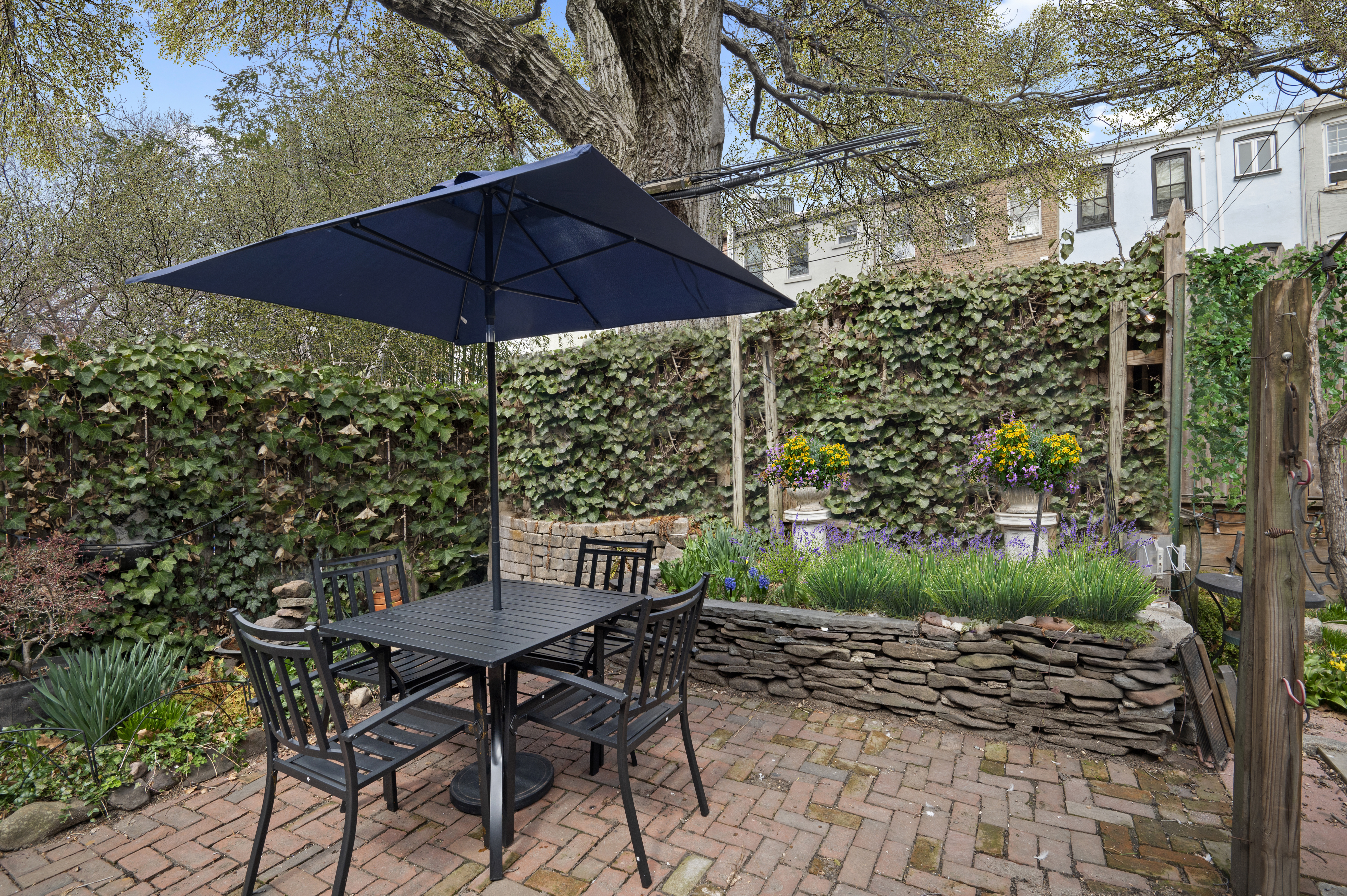 457 Warren Street Brooklyn, NY 11217 - Photo 14 of 16 a view of yard with table and chairs under an umbrella