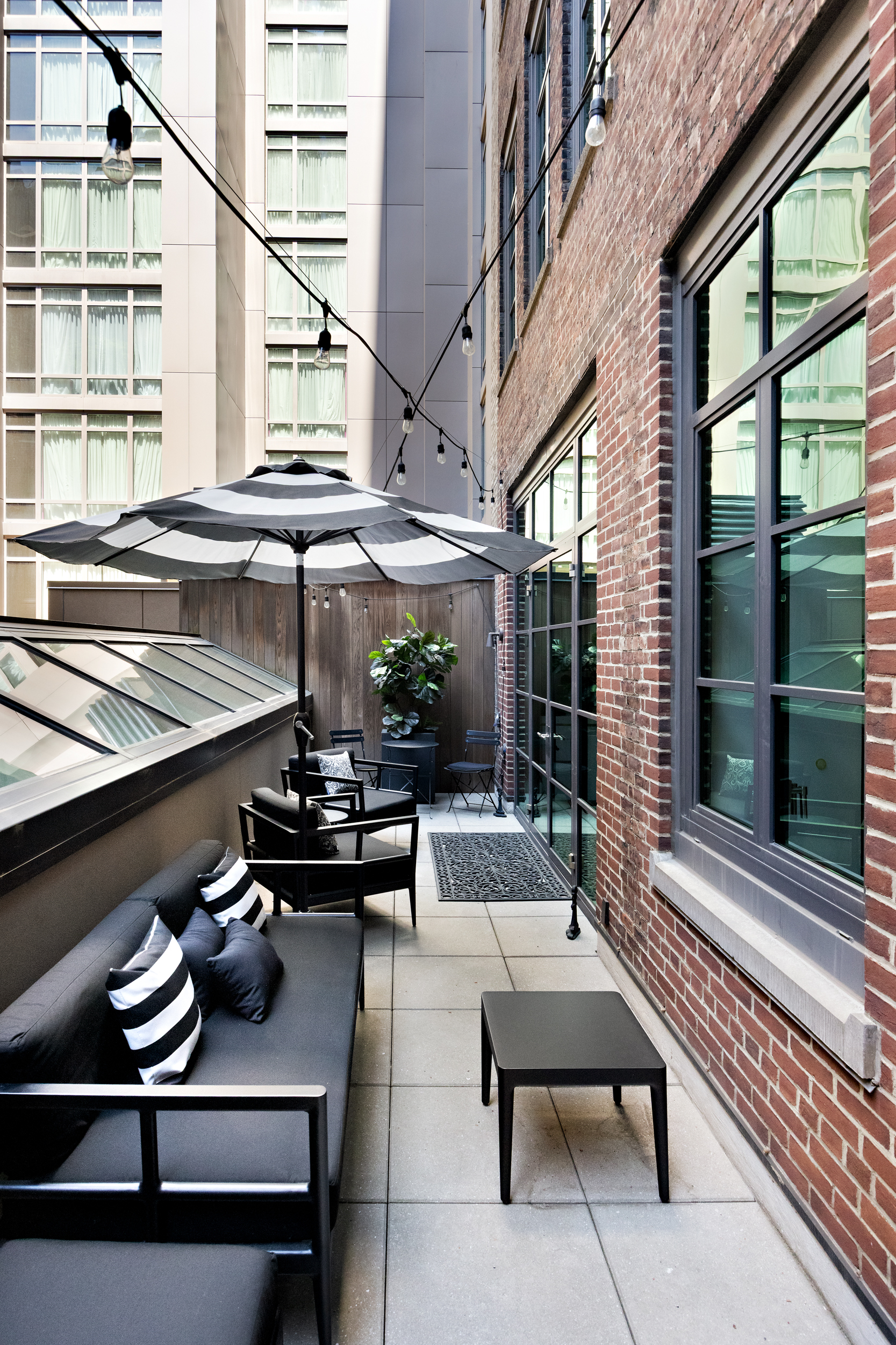404 Park Avenue South, Unit 3E Manhattan, NY 10016 - Photo 4 of 21 a view of a balcony with chairs and wooden floor