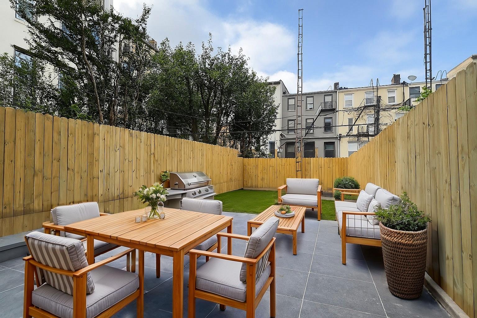 156 Summit Street, Unit 1 Brooklyn, NY 11231 - Photo 2 of 6 a backyard of a house with table and chairs