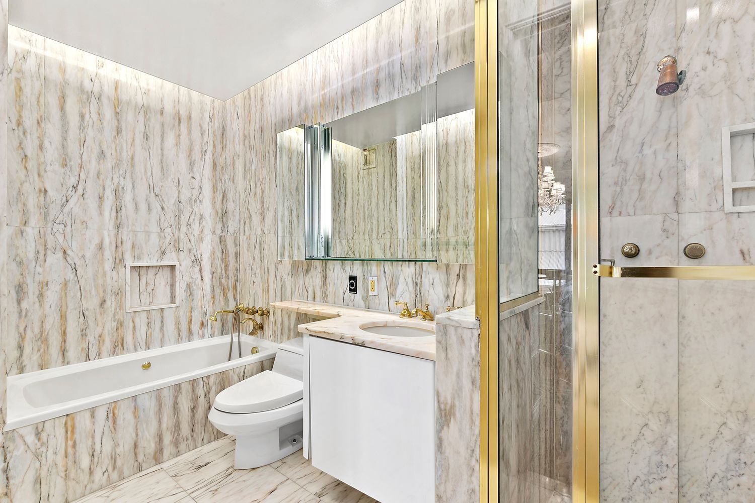 530 East 76th Street, Unit 10H Manhattan, NY 10021 - Photo 14 of 26 a bathroom with a granite countertop sink toilet and shower