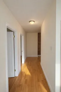 a view of hallway with wooden floor