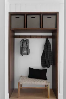 a living room with a couch and a potted plant on the wall