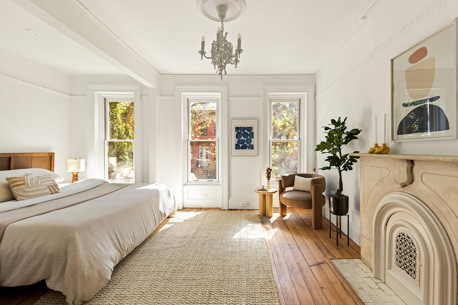 467 11th Street Brooklyn, NY 11215 - Photo 7 of 14 a spacious bedroom with a large bed a chandelier and windows