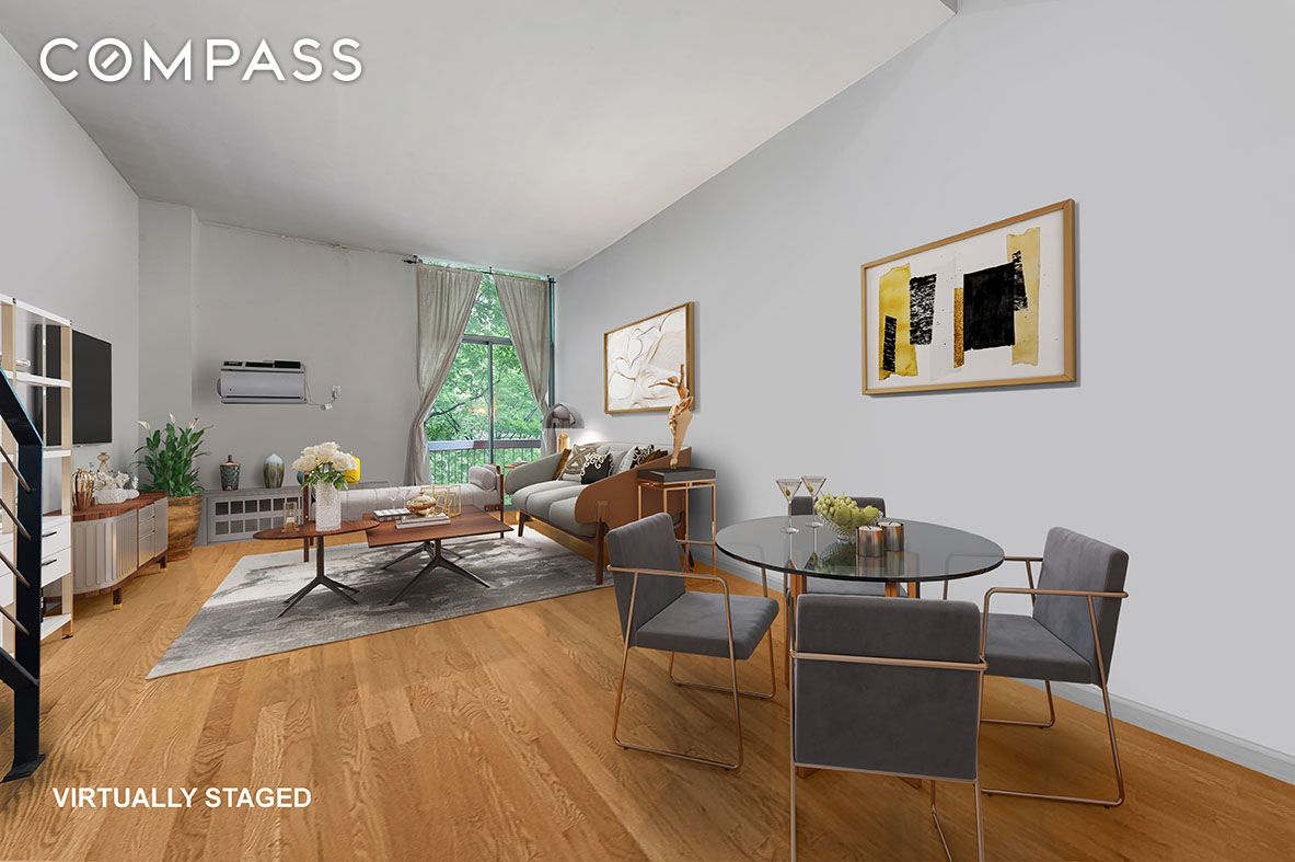 184 Thompson Street, Unit 1E Manhattan, NY 10012 - Photo 2 of 8 a living room with furniture and a large window