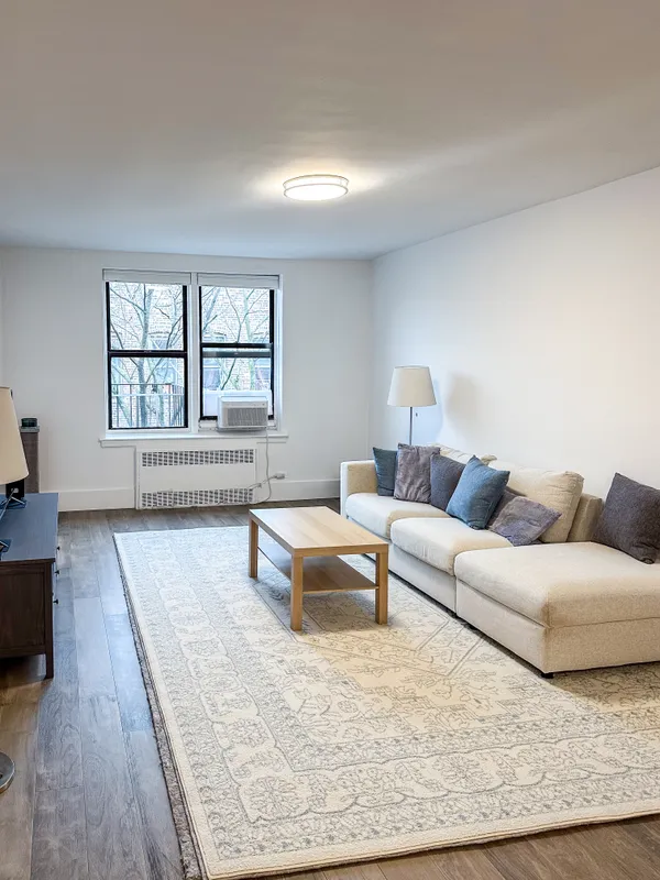 a living room with furniture and a large window