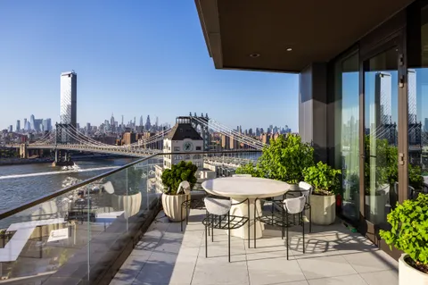 a balcony with chairs and table