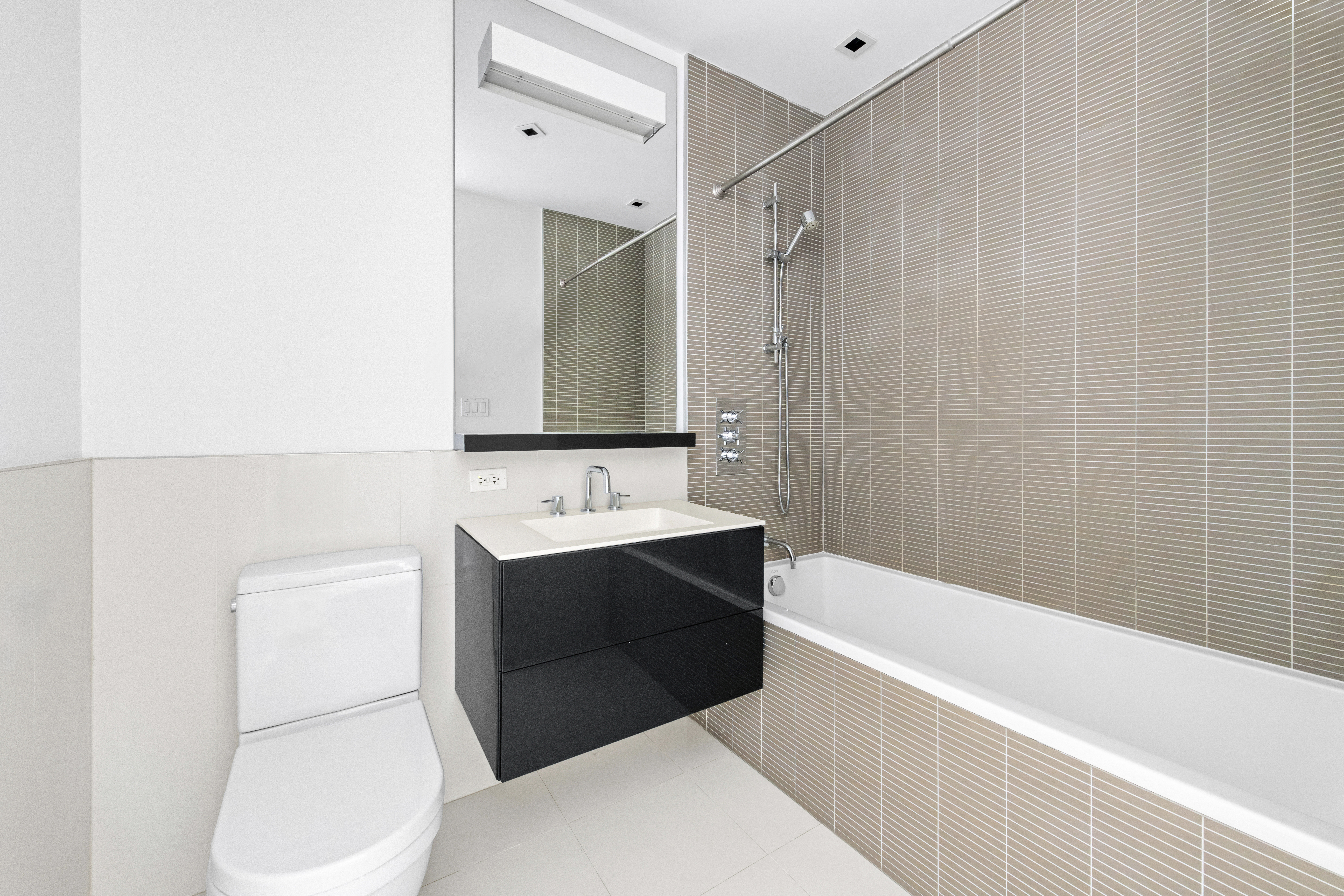 300 East 23rd Street, Unit 7A Manhattan, NY 10010 - Photo 7 of 15 a bathroom with a sink toilet and shower