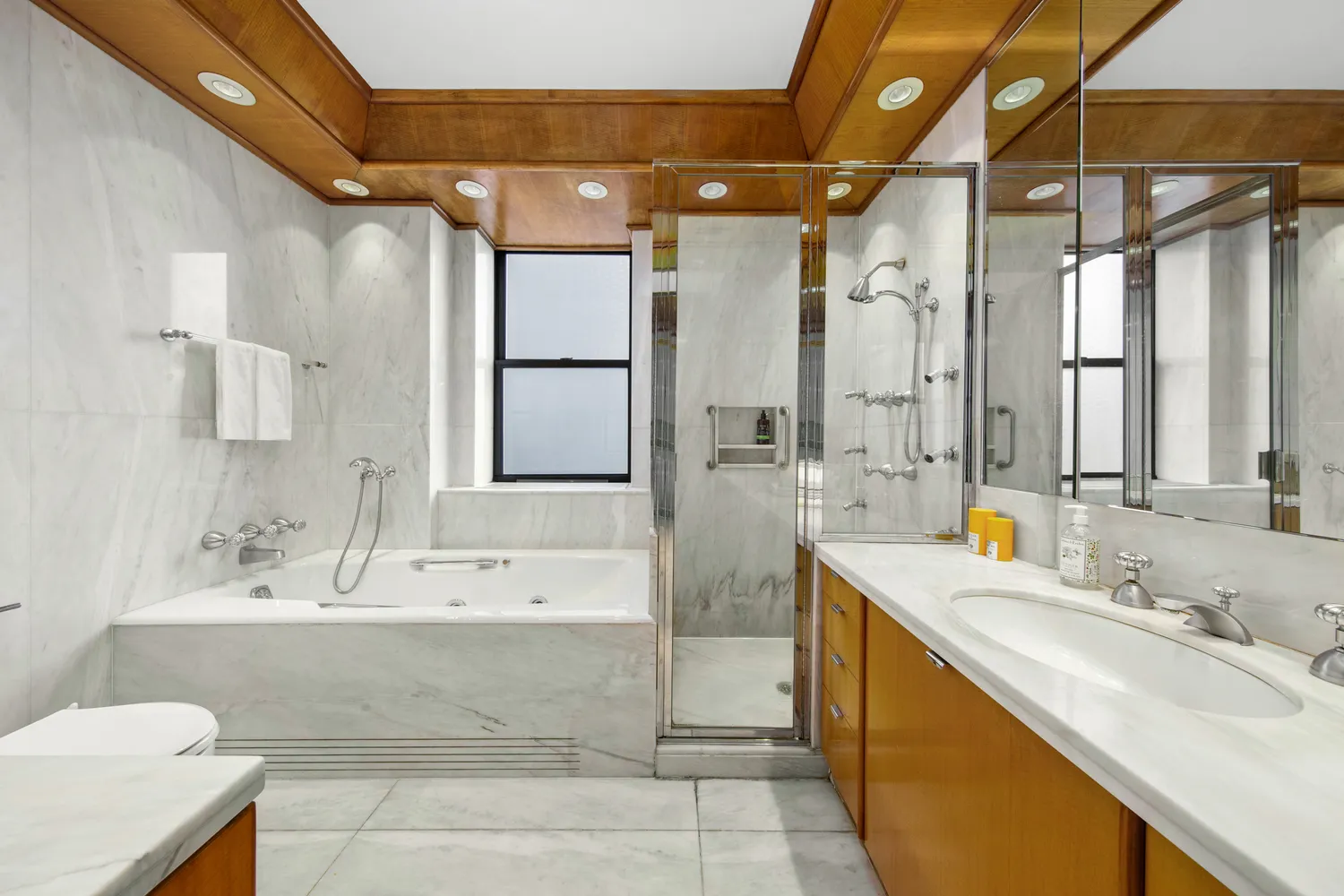 a bathroom with a tub sink and mirror