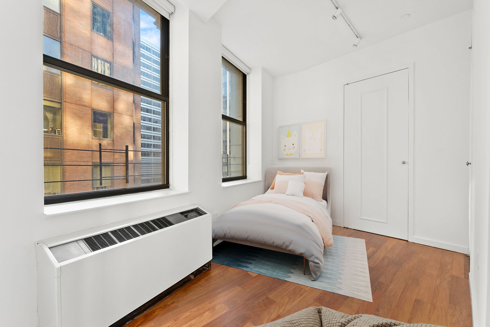 1 Wall Street Court, Unit 1405 Manhattan, NY 10005 - Photo 14 of 19 a bedroom with a bed and a window