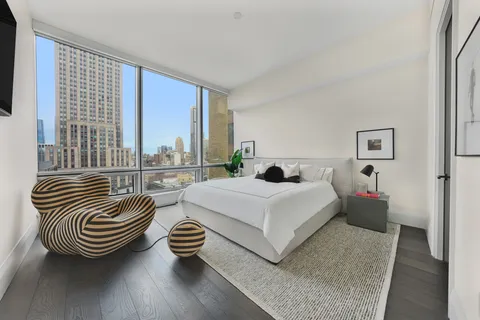 a bedroom with furniture and a window