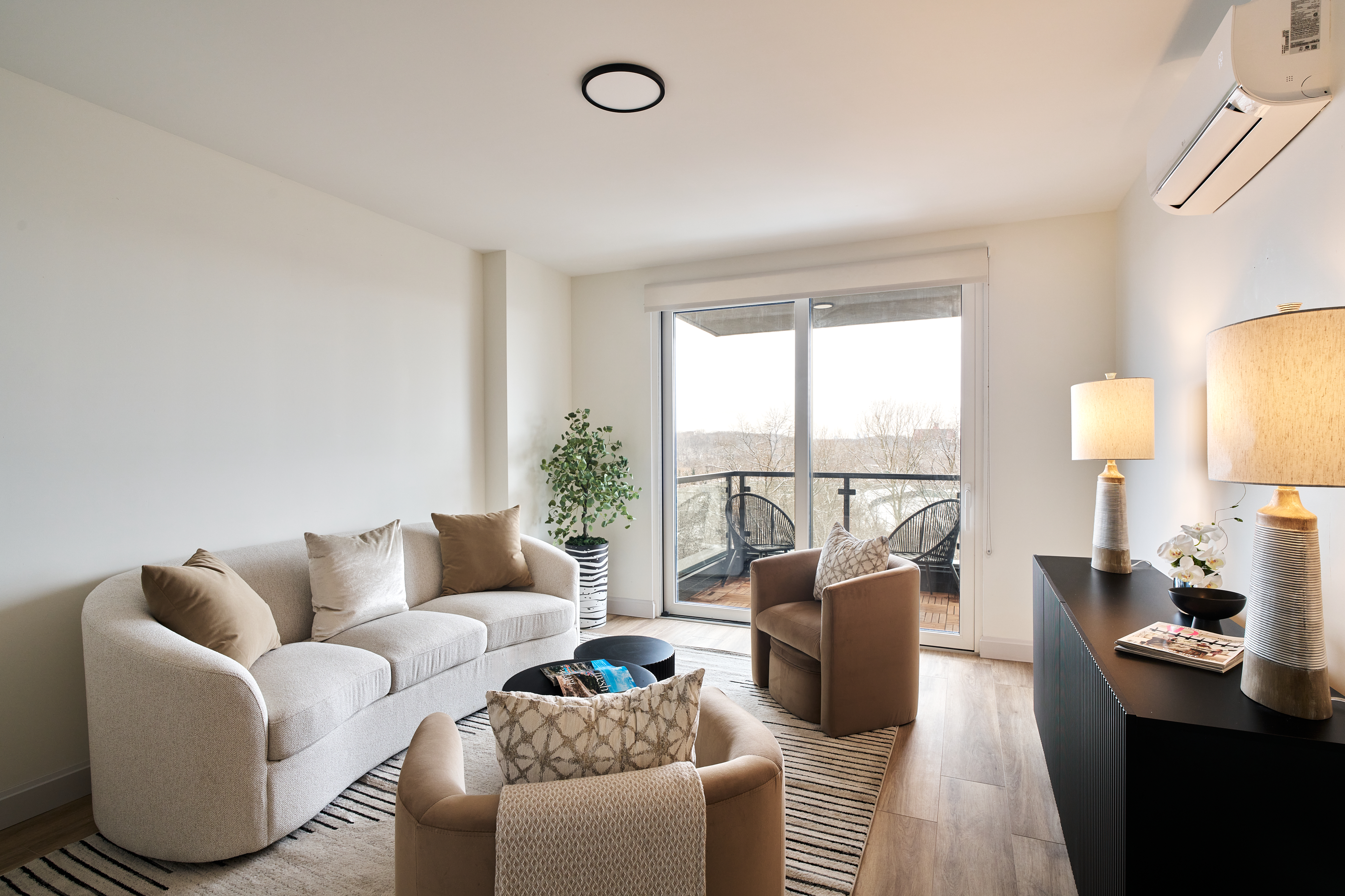 a living room with furniture and a large window