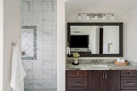 a view of swimming pool with lawn chairs and plants