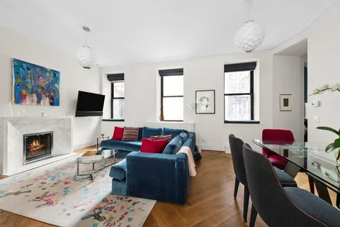 a living room with furniture fireplace and window