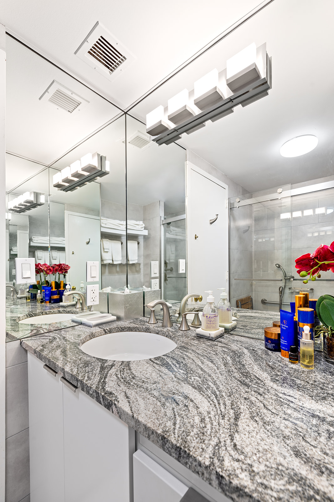 188 East 70th Street, Unit 8E Manhattan, NY 10021 - Photo 6 of 10 a bathroom with a sink mirror and vanity