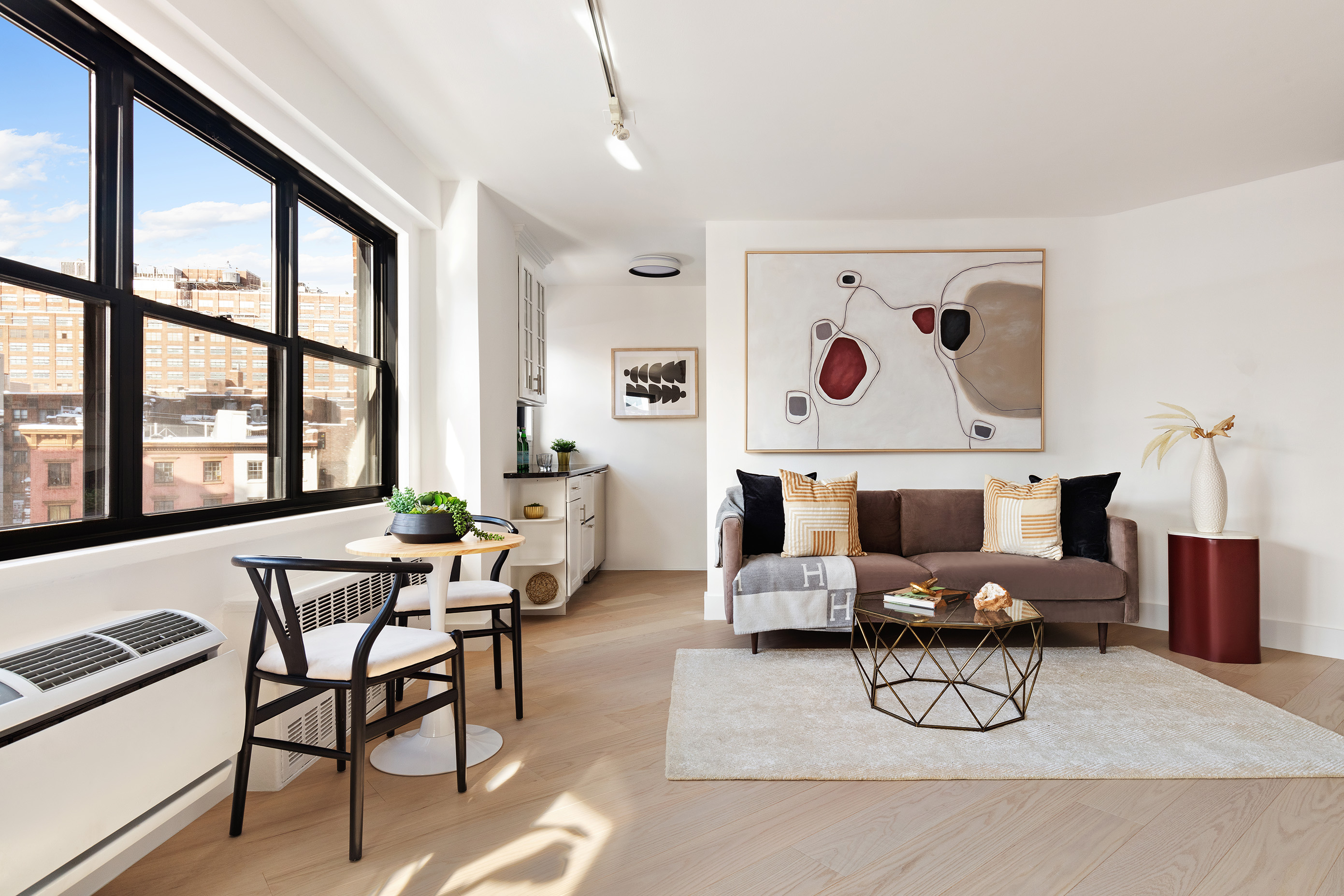 31 Jane Street, Unit 5A Manhattan, NY 10014 - Photo 4 of 13 a living room with furniture and a large window