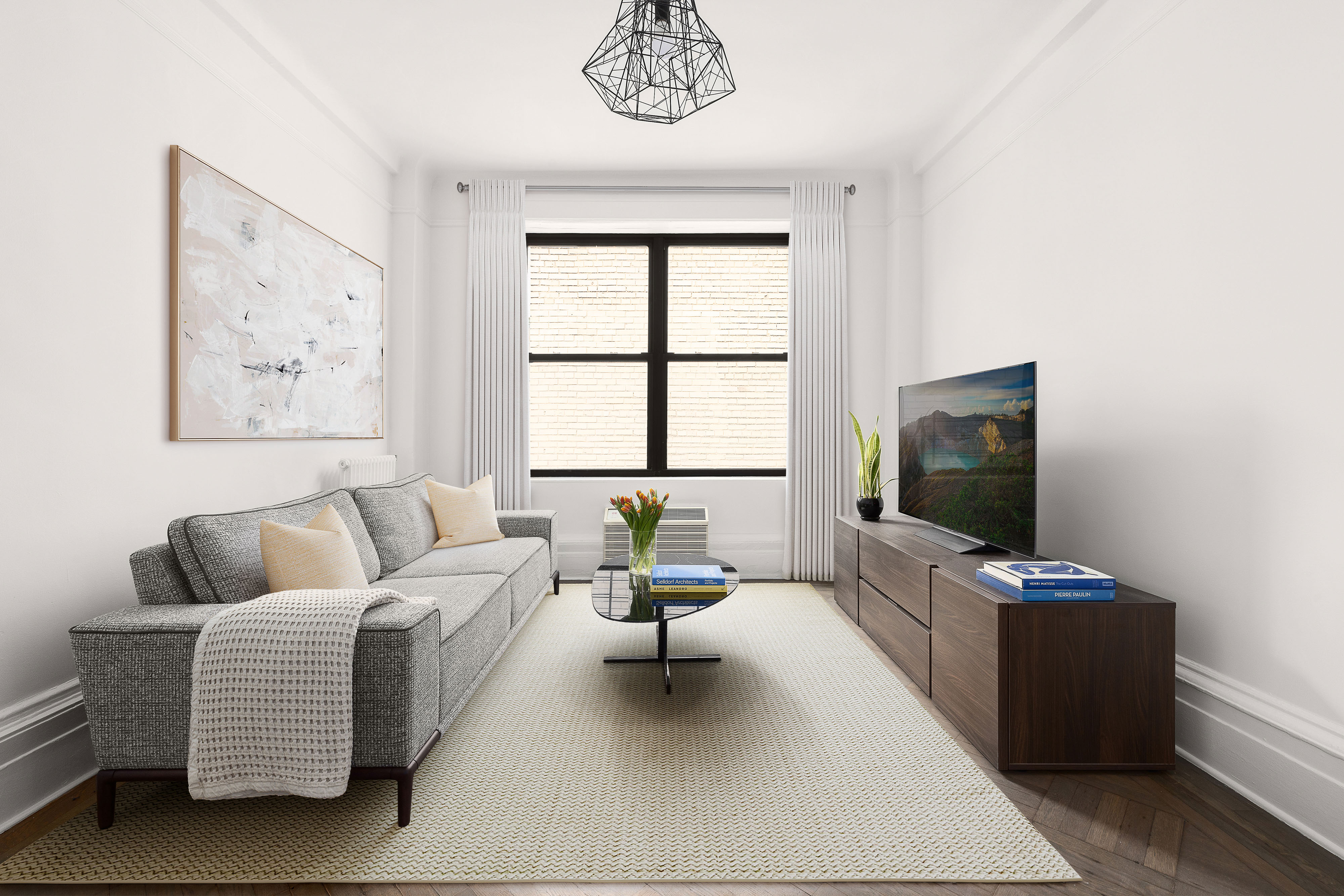 55 West 95th Street, Unit 93 Manhattan, NY 10025 - Photo 5 of 11 a living room with furniture and a flat screen tv