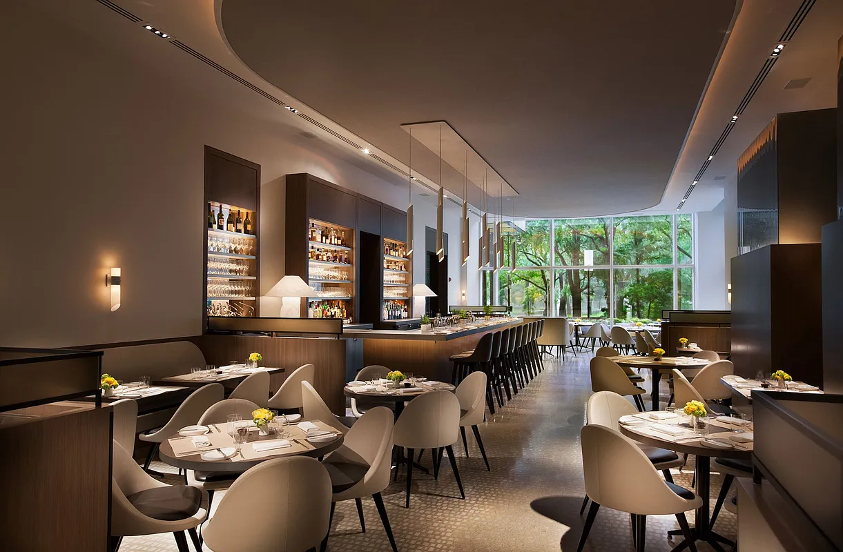 1 Central Park West, Unit 1218 Manhattan, NY 10023 - Photo 8 of 11 a living room with furniture a large window and a flat screen tv