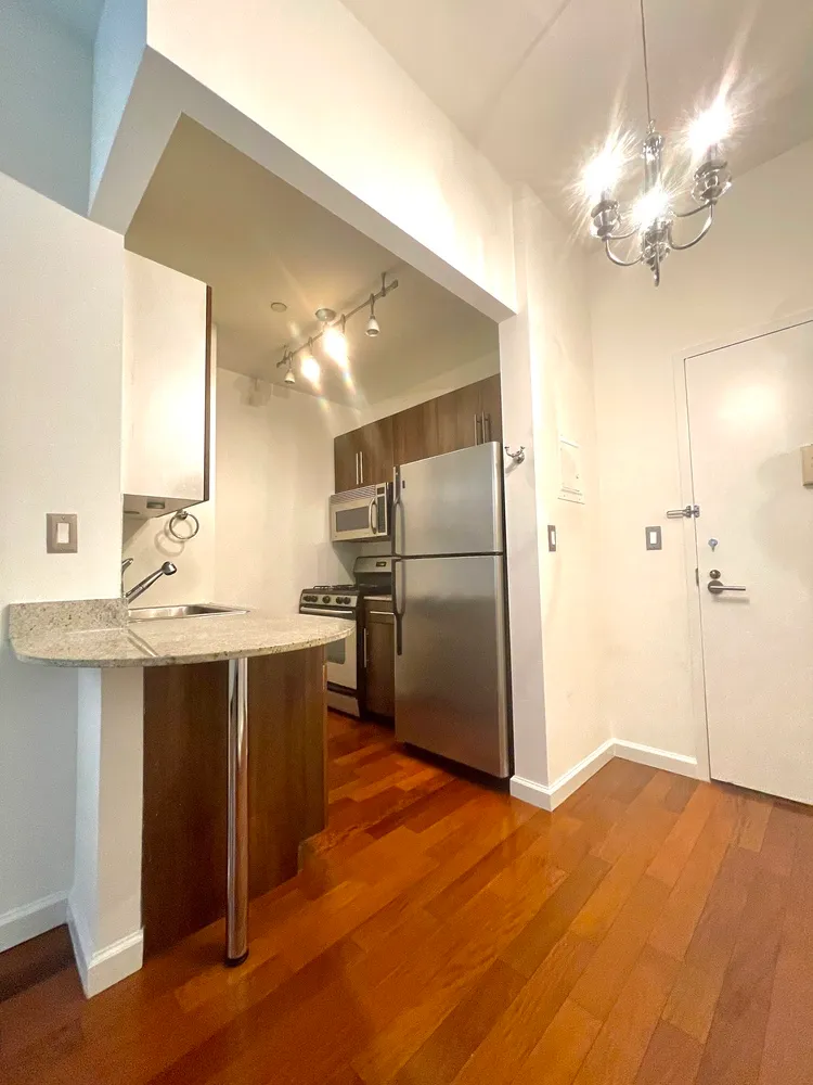 a kitchen with kitchen island a sink appliances and cabinets