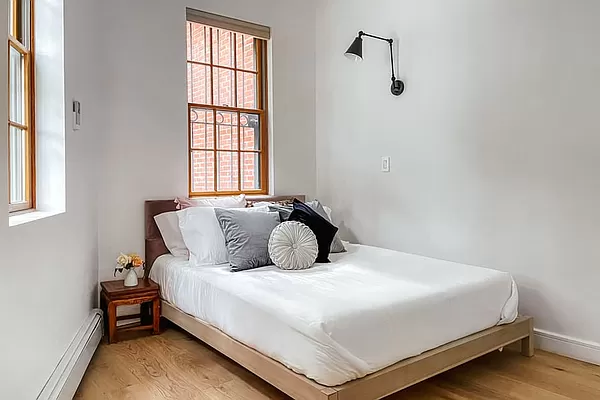 334 Plymouth Street Brooklyn, NY 11201 - Photo 23 of 32 a bedroom with a bed and window