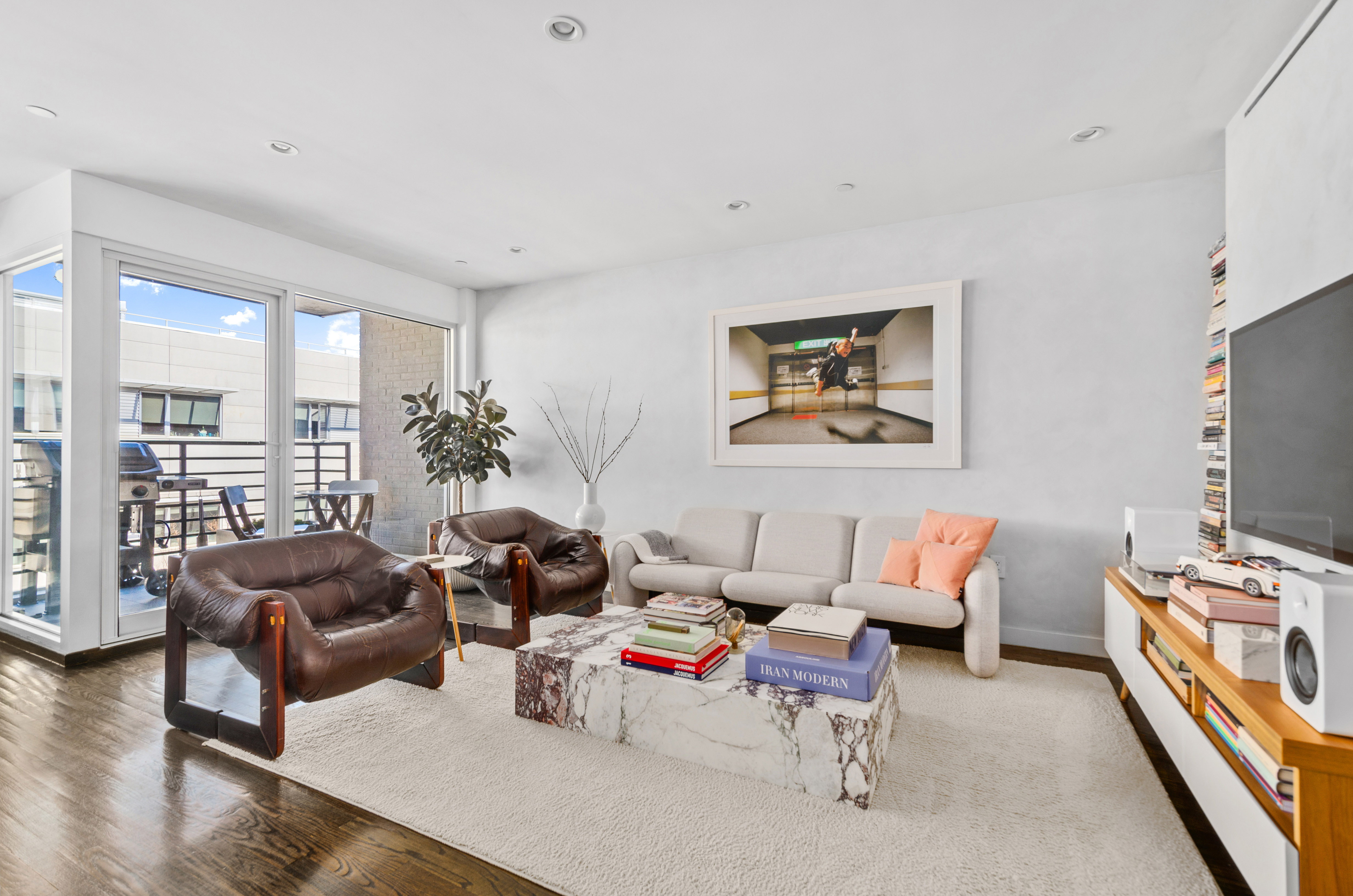 48 Box Street, Unit 5 Brooklyn, NY 11222 - Photo 3 of 10 a living room with furniture or couch and a flat screen tv