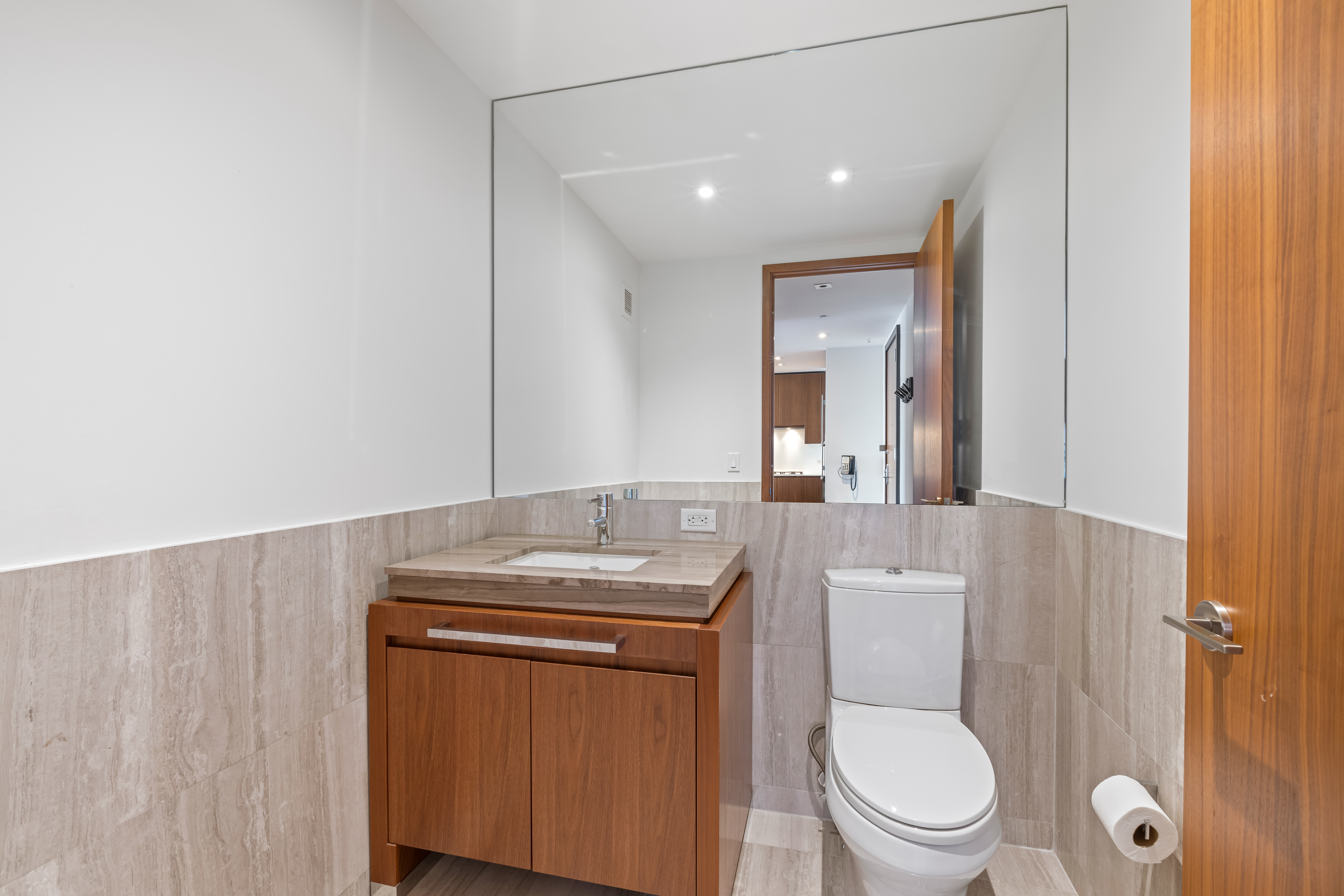 400 5th Avenue, Unit 49C Manhattan, NY 10018 - Photo 13 of 21 a bathroom with a granite countertop toilet sink and mirror