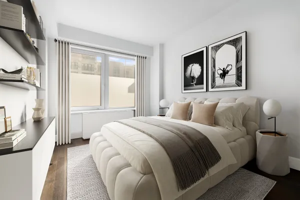 a bedroom with a large bed and a painting on the wall