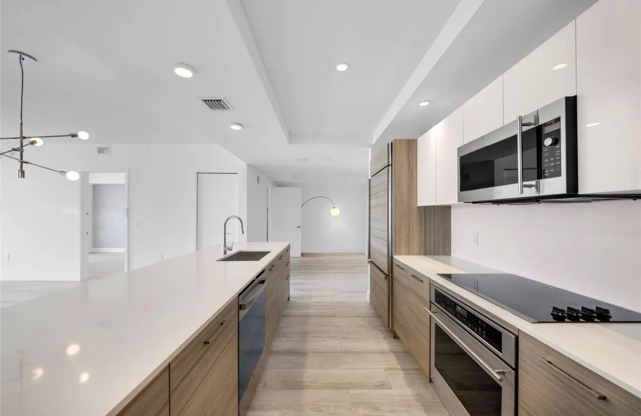 a large kitchen with stainless steel appliances kitchen island a large counter space a sink and cabinets