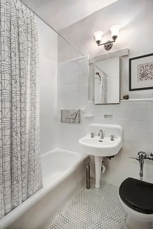 344 West 12th Street, Unit 1A Manhattan, NY 10014 - Photo 12 of 17 a bathroom with a sink a bathtub and a mirror