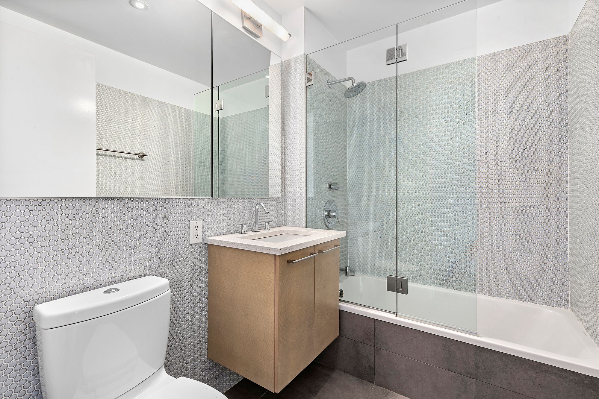 210 West 96th Street, Unit 6 Manhattan, NY 10025 - Photo 9 of 14 a bathroom with a sink a toilet and shower