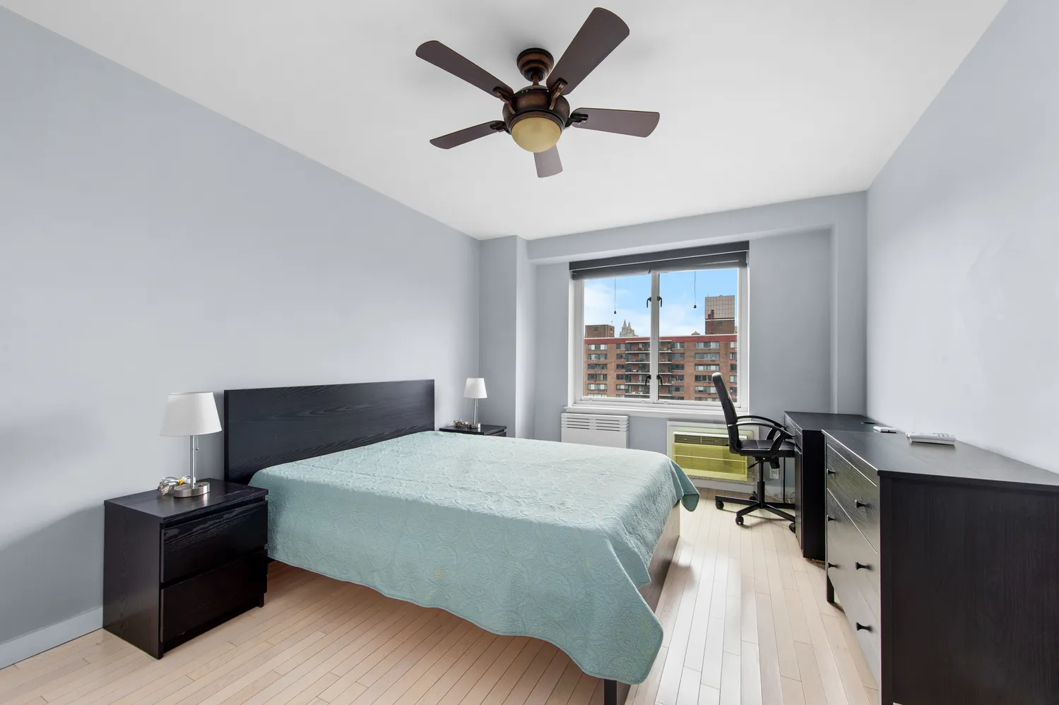 a bedroom with a bed and a desk