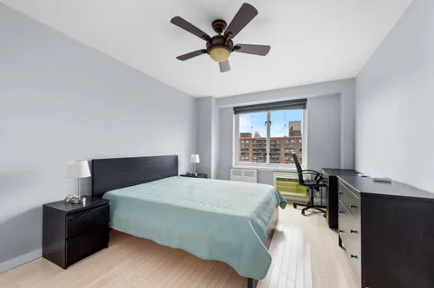 a bedroom with a bed and a desk