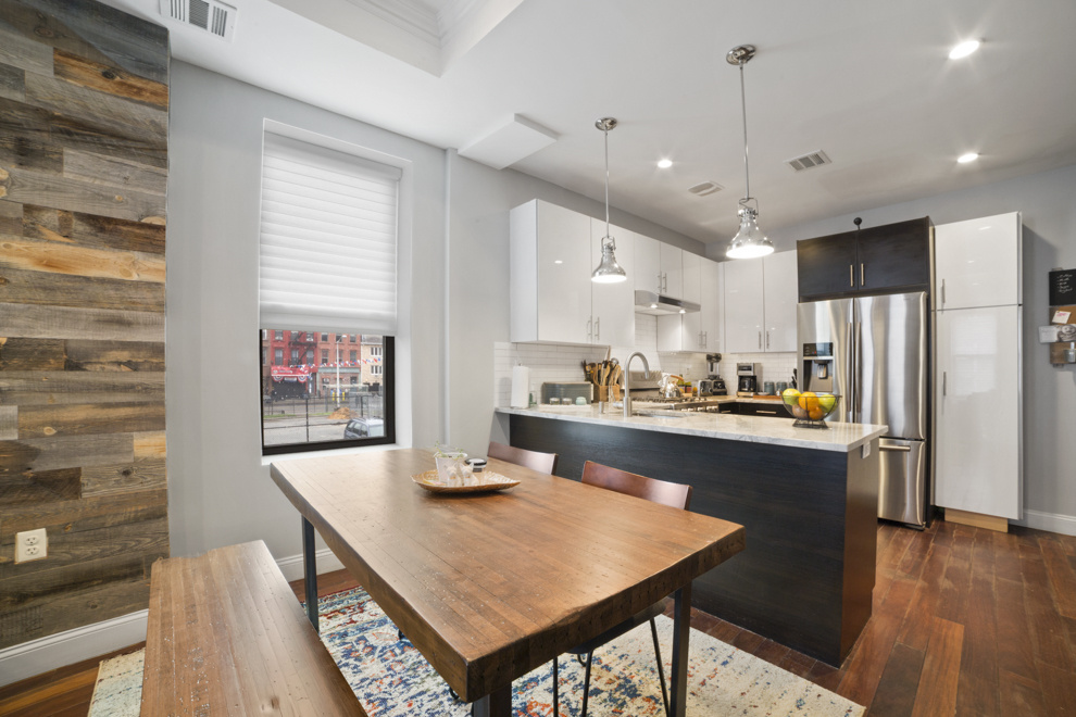 730 Quincy Street, Unit 2 Brooklyn, NY 11221 - Photo 3 of 11 a kitchen with stainless steel appliances a dining table chairs and a refrigerator