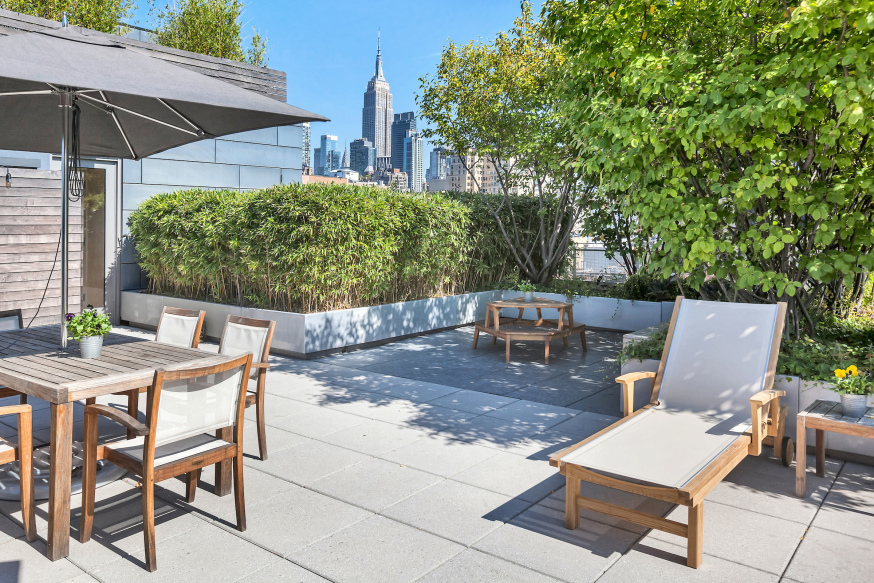 177 9th Avenue, Unit PHA Manhattan, NY 10011 - Photo 25 of 28 a view of a patio with table and chairs under an umbrella