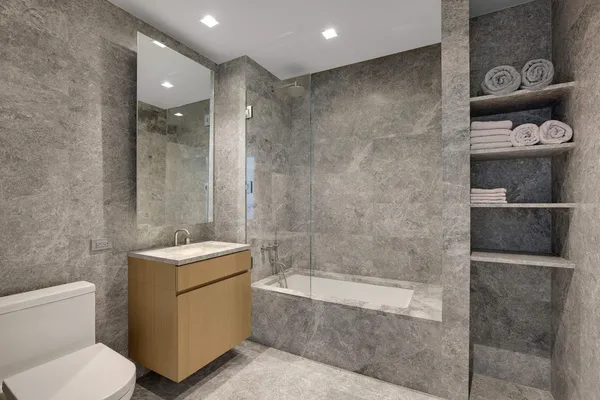 a bathroom with a toilet sink and shower
