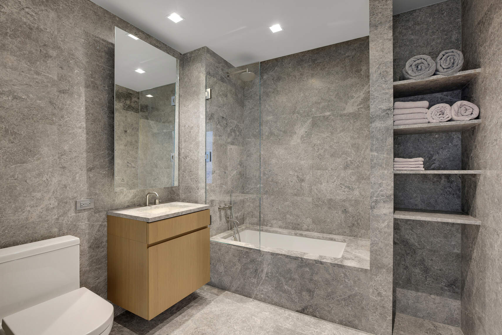611 West 56th Street, Unit 2D Manhattan, NY 10019 - Photo 2 of 10 a bathroom with a toilet sink and shower