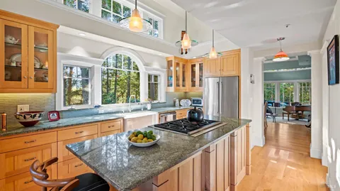 a kitchen with sink refrigerator and stove