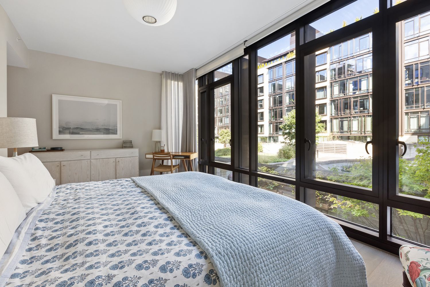 a bedroom with a large bed and a large window